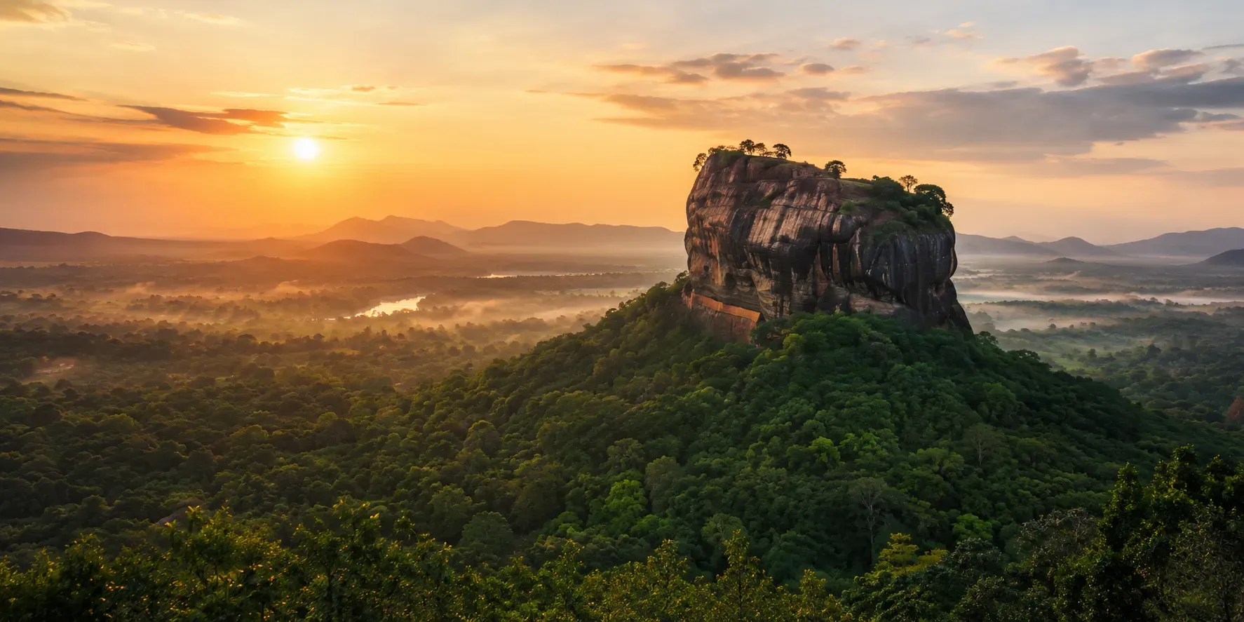 Sigiriya rock fortress rising above the forest at sunrise in Sri Lanka.