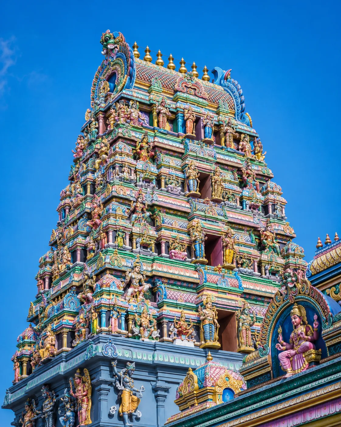 A colourful Hindu temple gopuram in Jaffna against a blue sky.