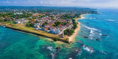 Sri Lanka's south coast from the air — Galle Fort headland, turquoise sea and palms.